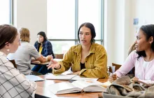 Students at table with notebooks