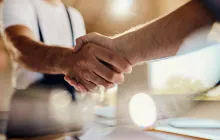 Factory workers shaking hands