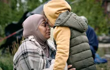 Mother in niqab with child face to face
