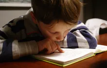 Young boy reading closeup