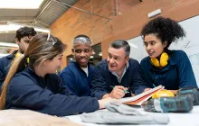 Mentor with apprentices in workshop