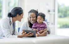 Smiling mother and child with doctor