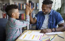 Teacher and student high-fiving
