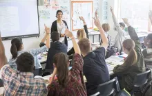 Teacher in front of a high school classroom