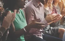 Row of people applauding