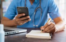 Doctor with phone and notepad