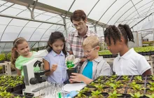 Teacher with students in a greenhouse