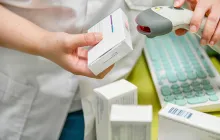 pharmacist scanning price on a package