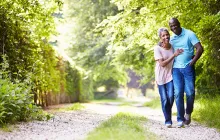Older African American couple walking outside