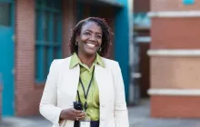 Principal outside a school holding a radio