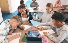Group of teenagers working on schoolwork at a table