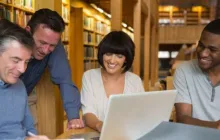 Four educators meeting at a library