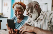 Older couple looking at a phone together