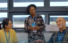A diverse group of teachers chatting with each other