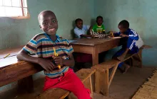 Boy smiling in Zambian classroom