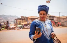woman in traditional african dress looking at phone