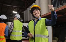 Factory worker giving the thumbs up