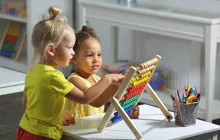 Preschoolers playing with a toy together