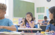 young girl in classroom working at her desk