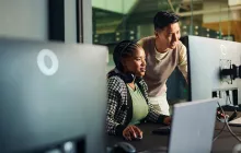 coworkers looking at computer monitor together