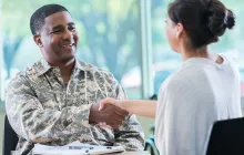 man in military uniform shaking hands