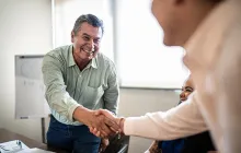 man shaking hands at job interview