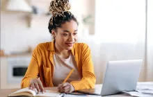 College student studying with laptop and notebook