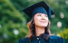 Young female college student in cap and gown