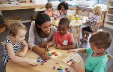 Preschool teacher with young students in classroom