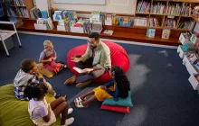 Teacher in library with young students