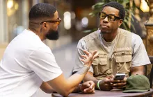African American men talking at a cafe