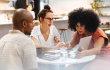 Colleagues working together at small table