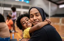 Father and daughter embracing at community center