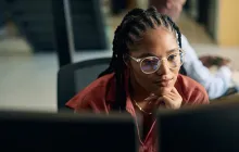 Thoughtful programmer working at her computer
