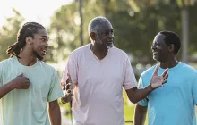 Three African American men walking and talking outside