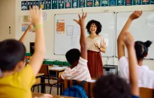 Smiling teacher in front of classroom