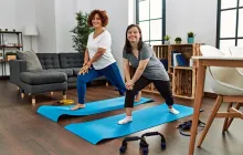 Young woman with Down syndrome and her mother doing yoga