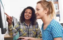 Supervisor and trainee at computer