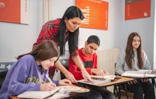 Teacher helping student in class.