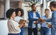 Diverse group of coworkers greeting each other