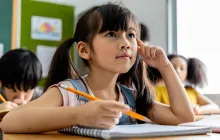 Elementary student with notebook in classroom
