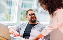 Male and female coworkers at a laptop