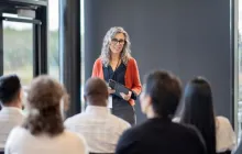 Education leader talking to educators in a classroom