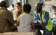 Volunteers Assisting Family during Community Relief Support Meeting