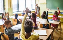 Girl raising her hand in classroom
