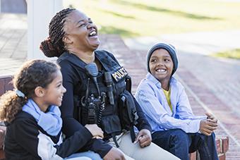 Policewoman laughing with children