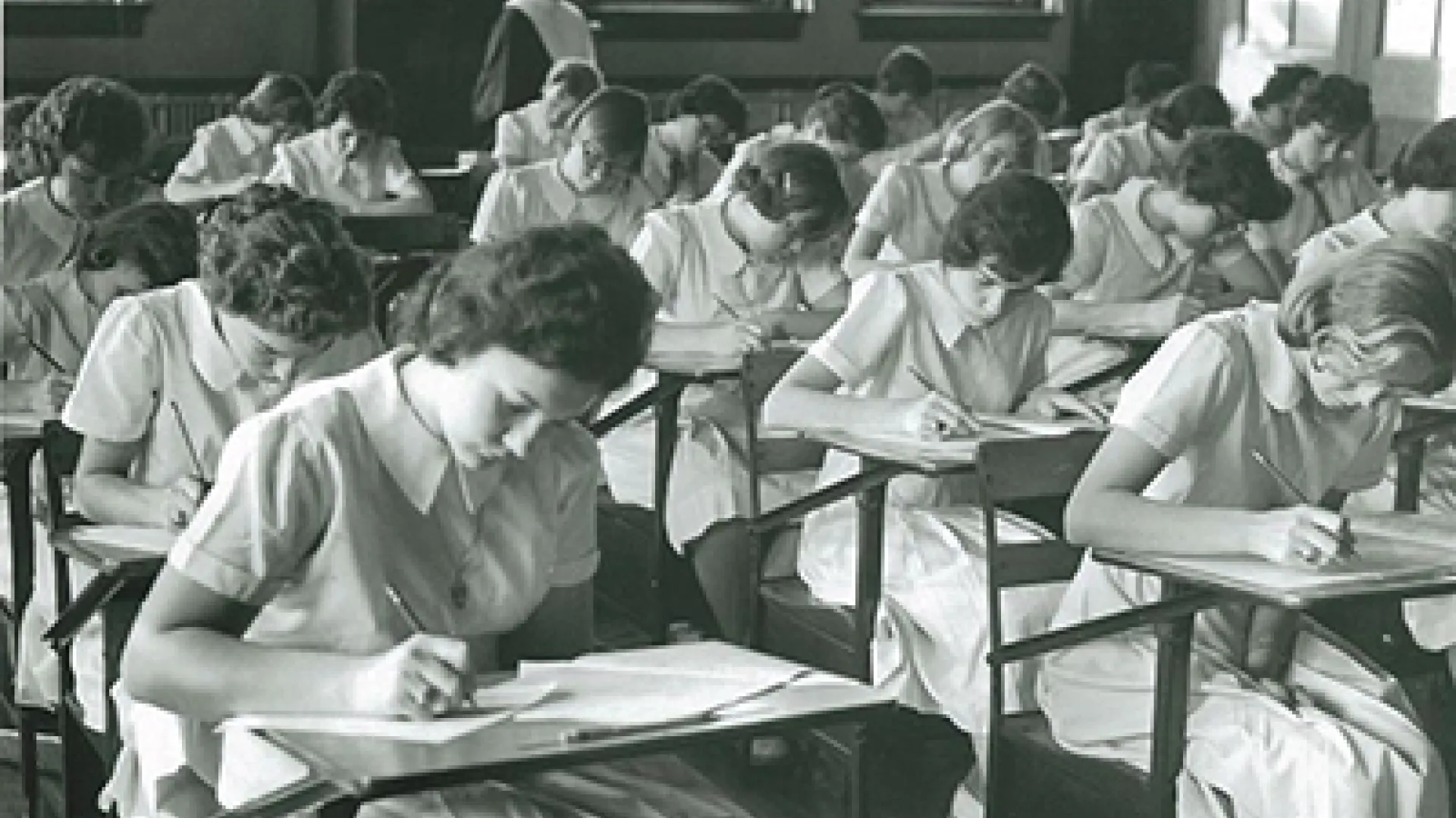 Image of students from the 1960s taking a test in a classroom