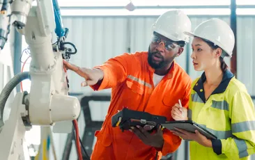 Supervisor and trainee in factory