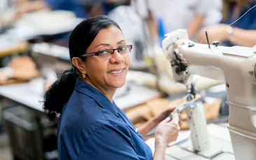 Latin American factory worker with sewing machine