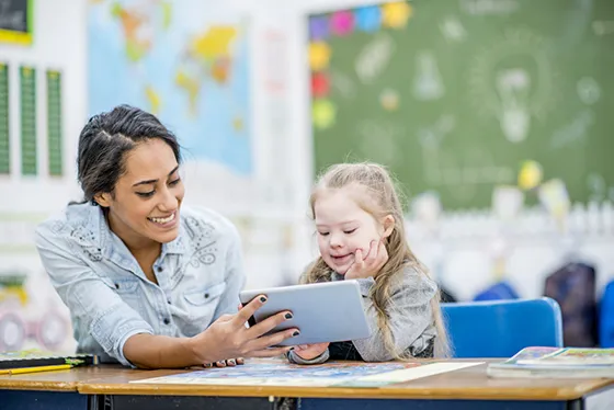 teacher and student looking at ipad